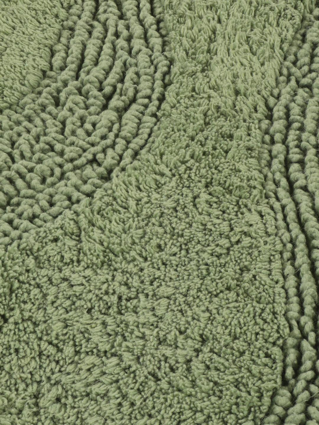 Tapis de bain rond vert avec un motif de vagues texturé