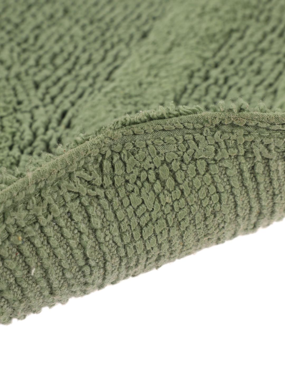 Tapis de bain rond vert avec un motif de vagues texturé