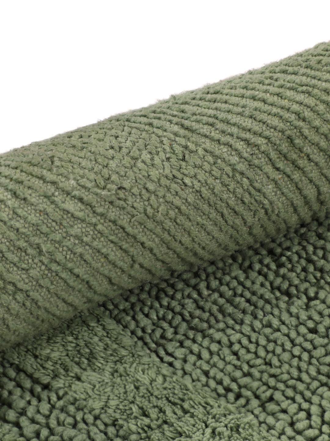 Tapis de bain rond vert avec un motif de vagues texturé