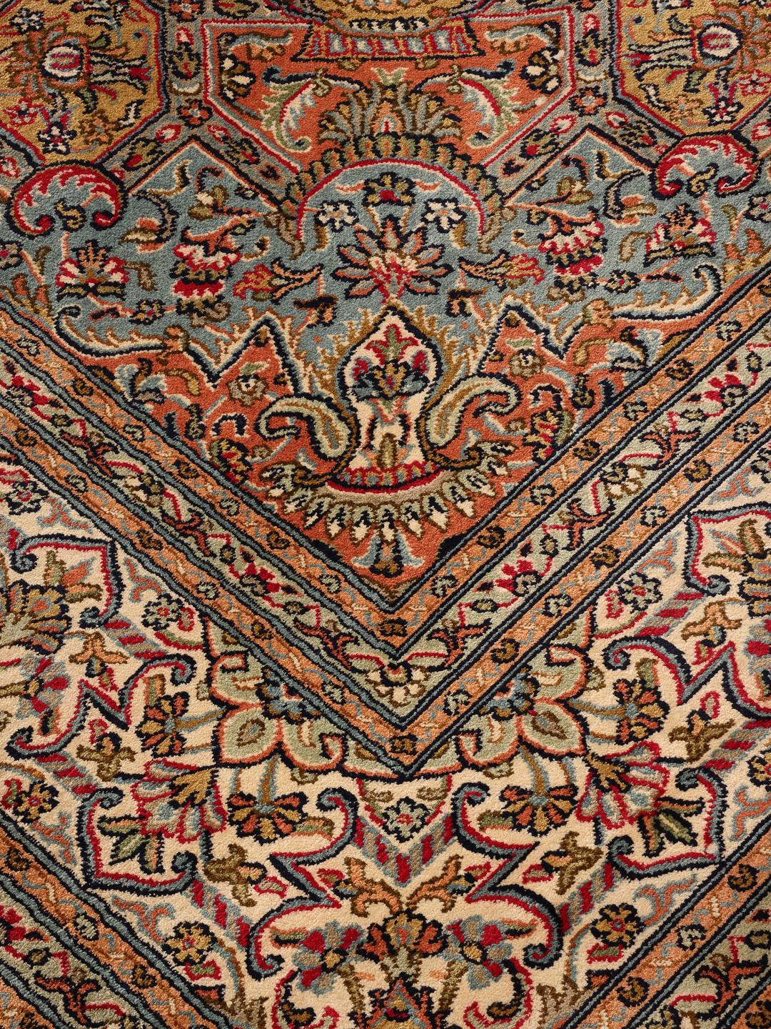 Et håndknyttet Kashmir-tæppe i silke fra Indien med et flerfarvet blomsterdesign.