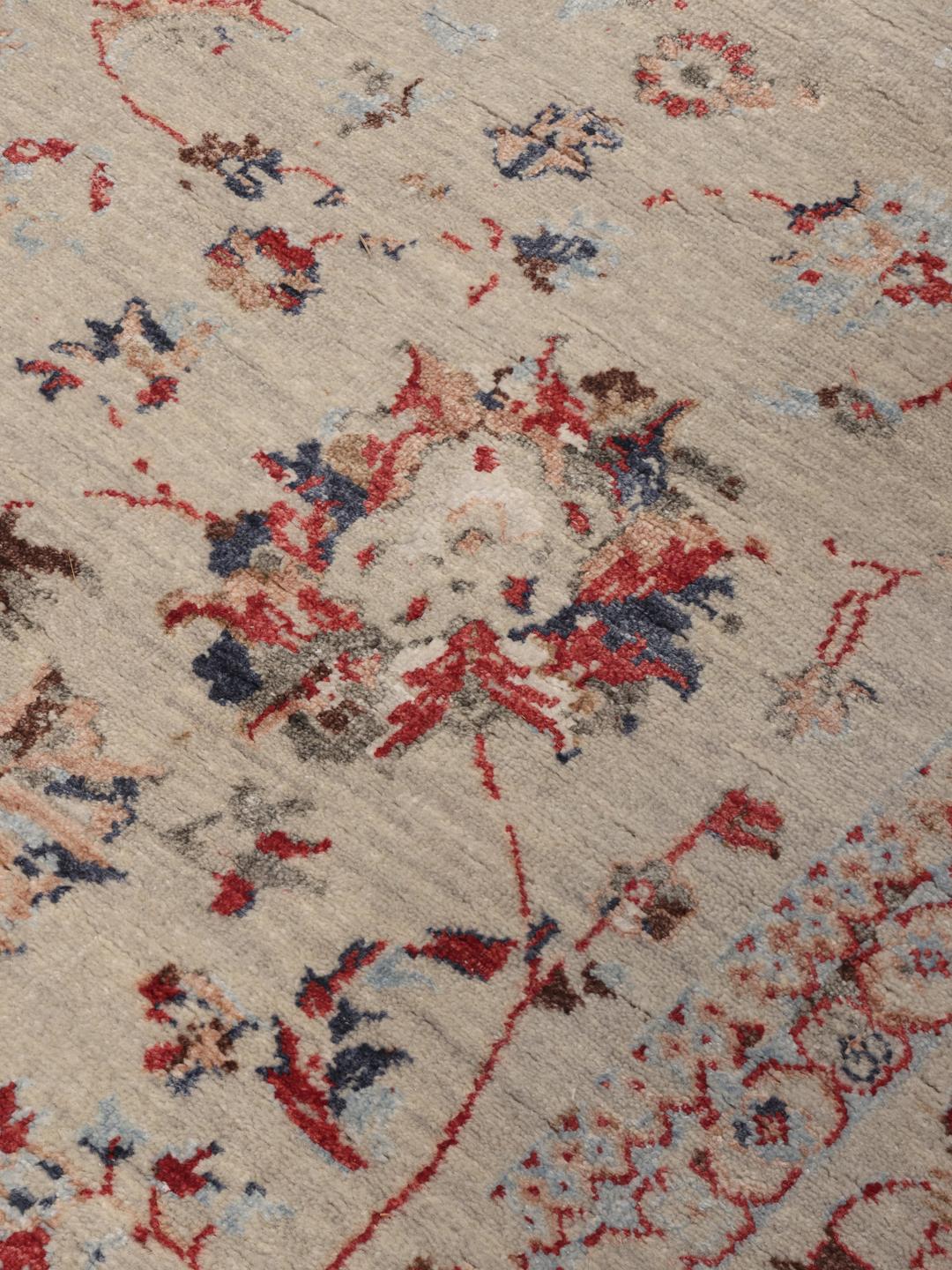 Håndknyttet beige tæppe med blomstermotiver af indisk oprindelse