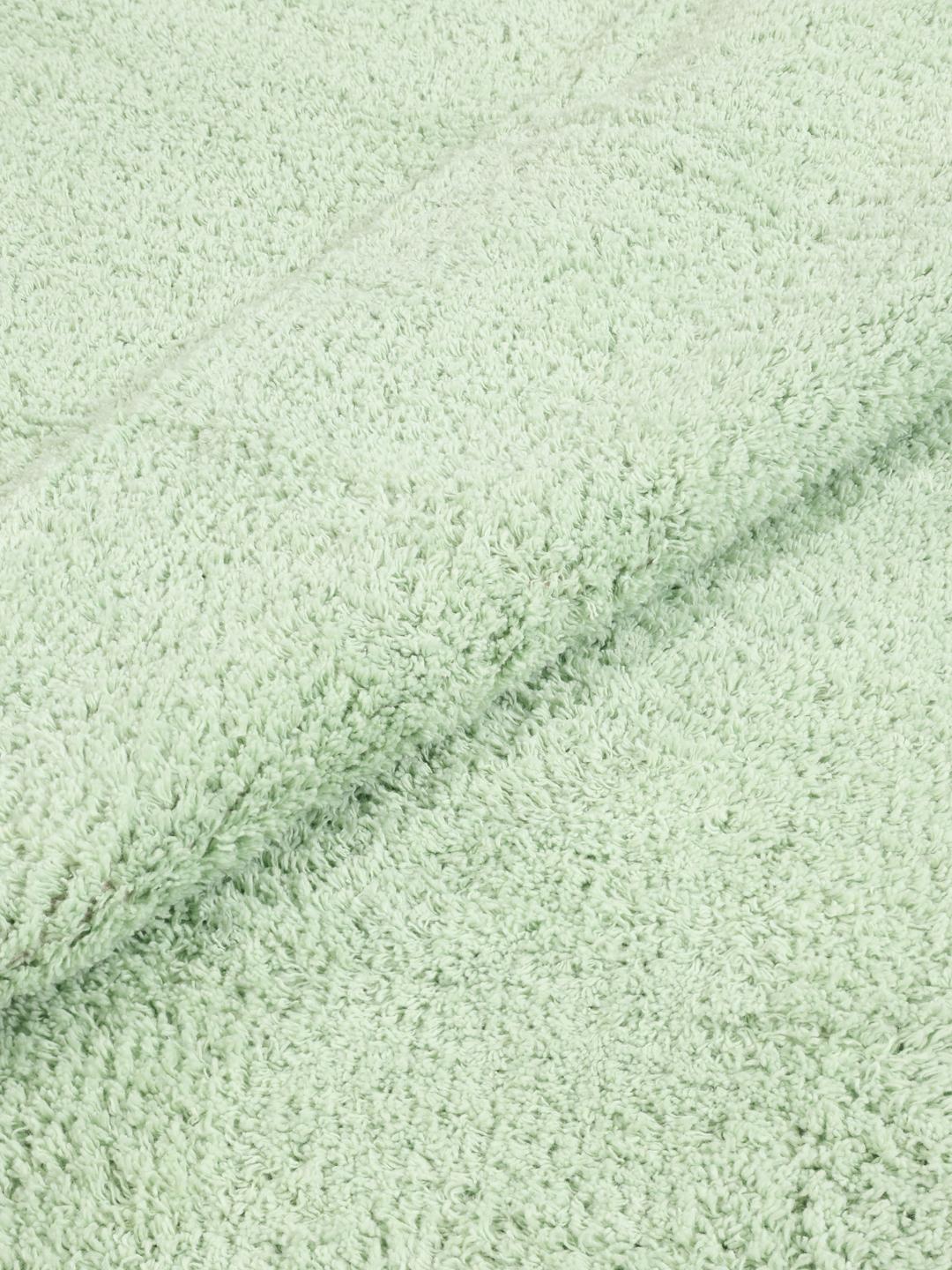 Een wolkvormig mintgroen tapijt