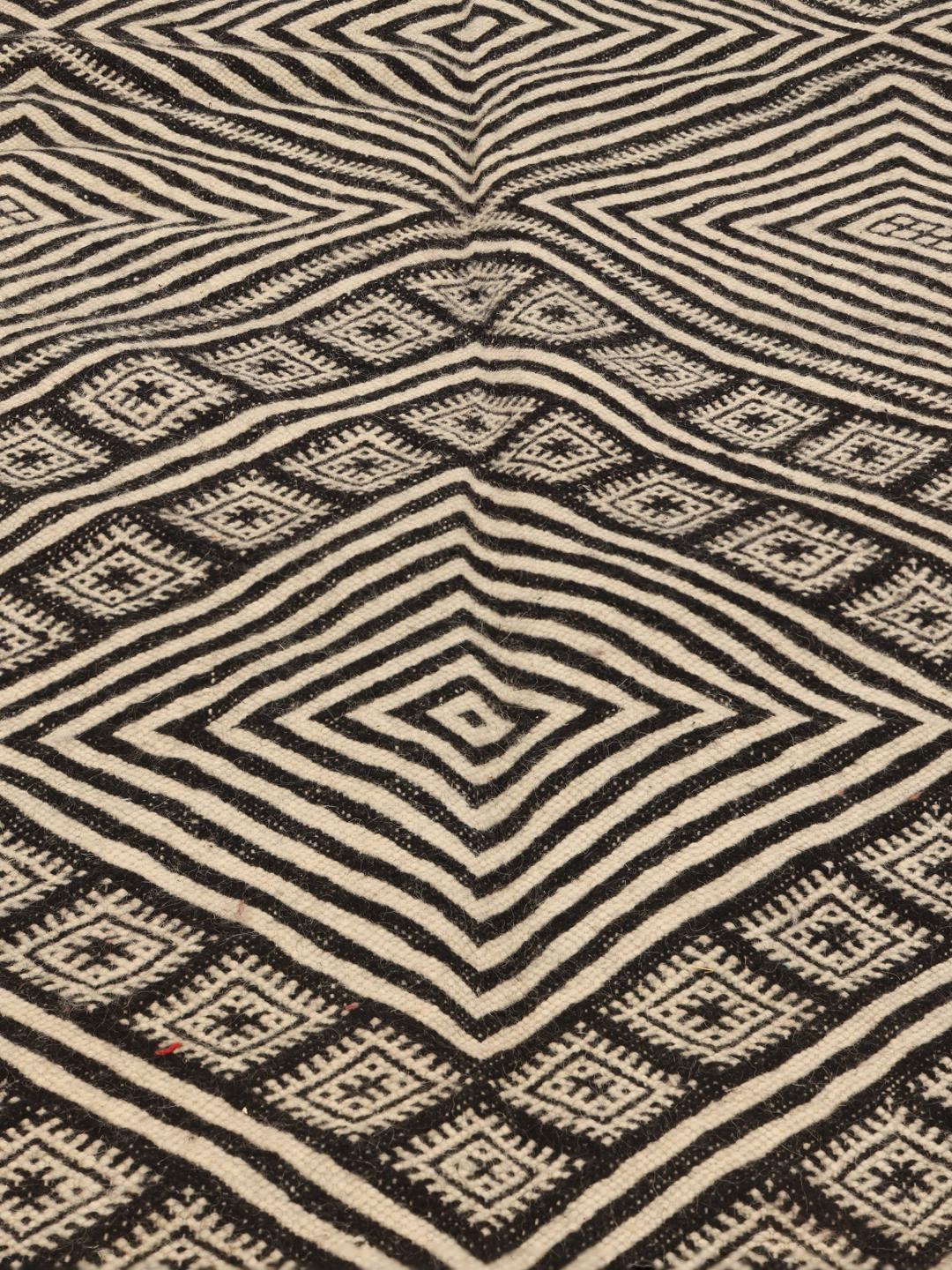 Handgeweven Marokkaans High Atlas Kelim vloerkleed met een geometrisch zwart en beige patroon