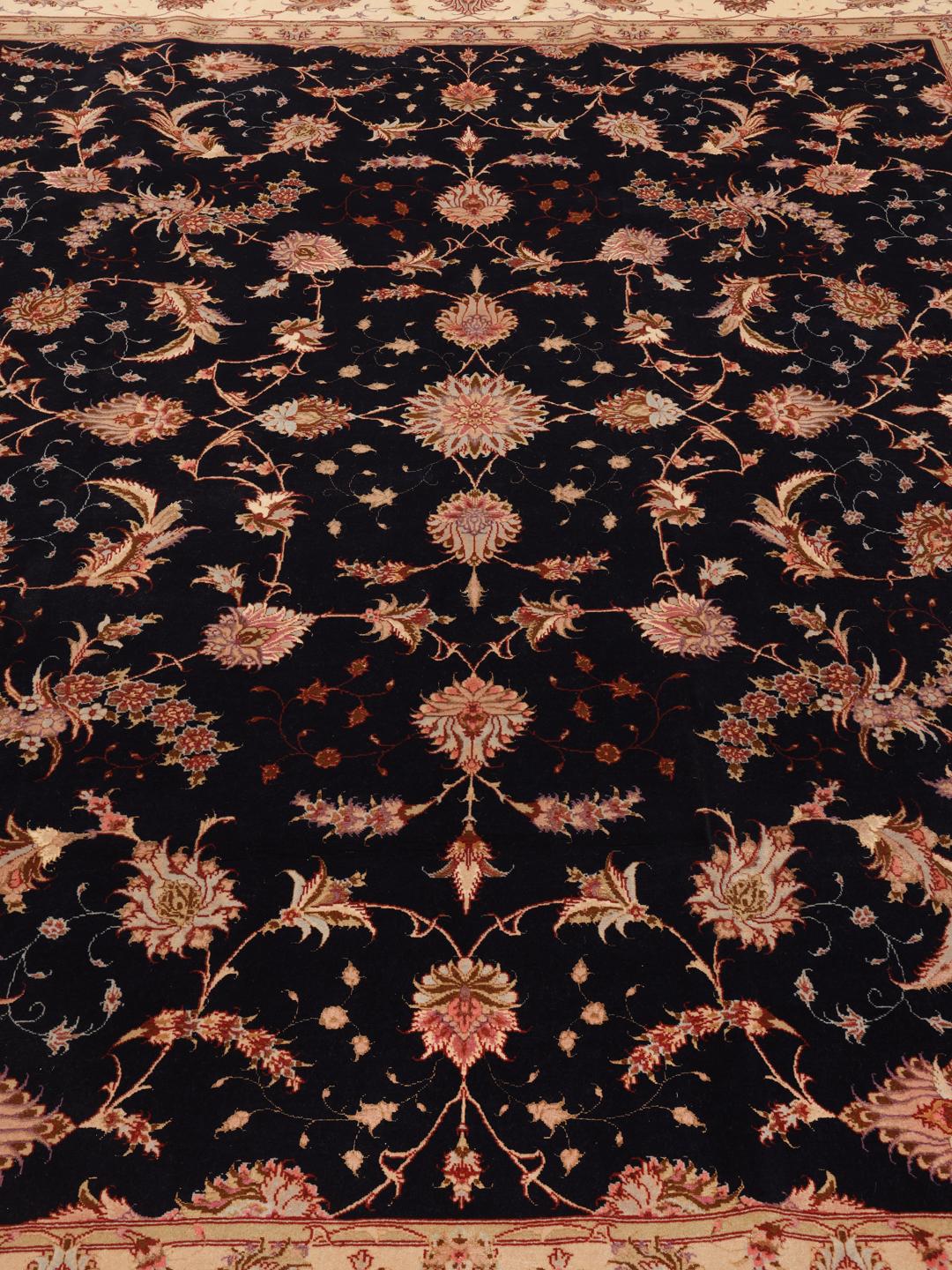 Hand-knotted Tabriz rug with a black field and floral patterns from the Middle East