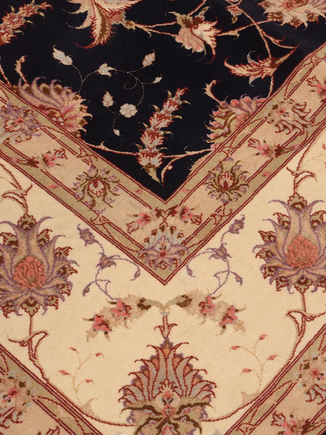 Hand-knotted Tabriz rug with a black field and floral patterns from the Middle East