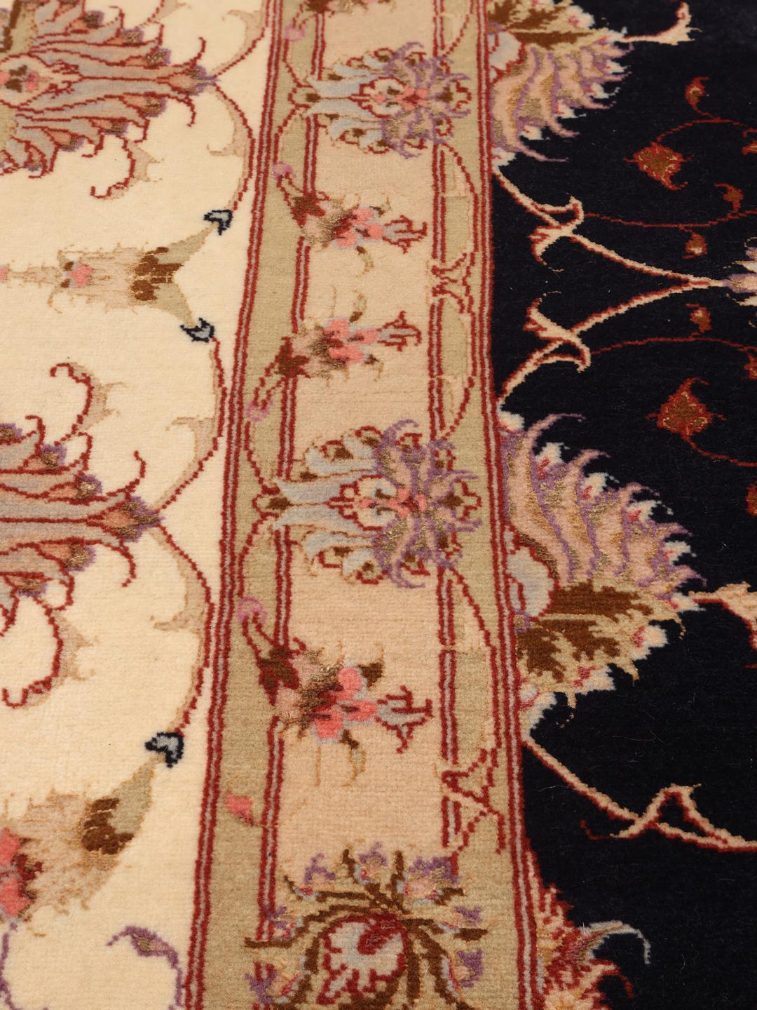 Hand-knotted Tabriz rug with a black field and floral patterns from the Middle East