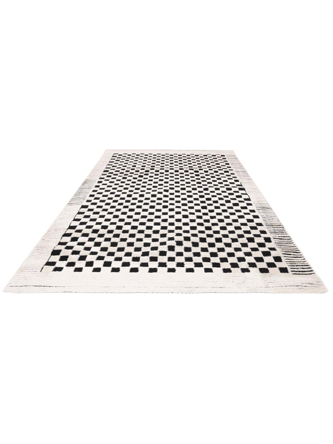 Tapis blanc crème et noir avec un motif structuré