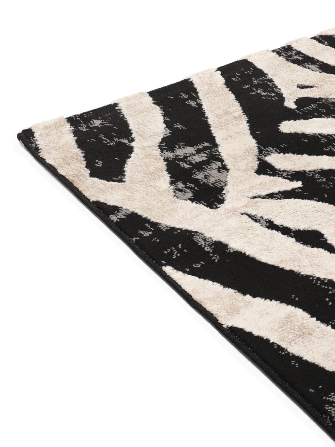Vloerkleed in zwart en beige met een dierenmotief