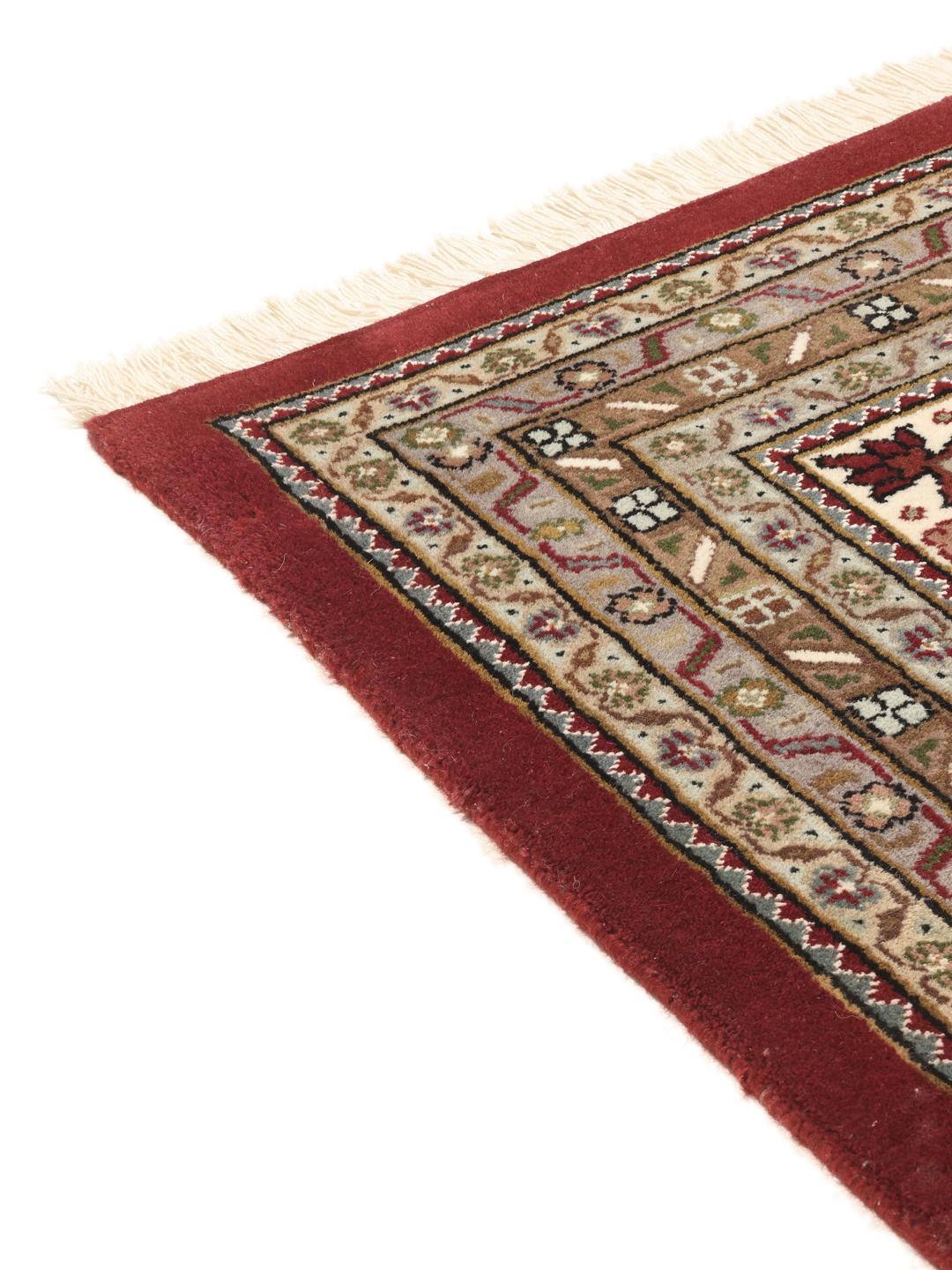 Tabriz Royal hand-knotted wool rug from India in deep red and beige tones