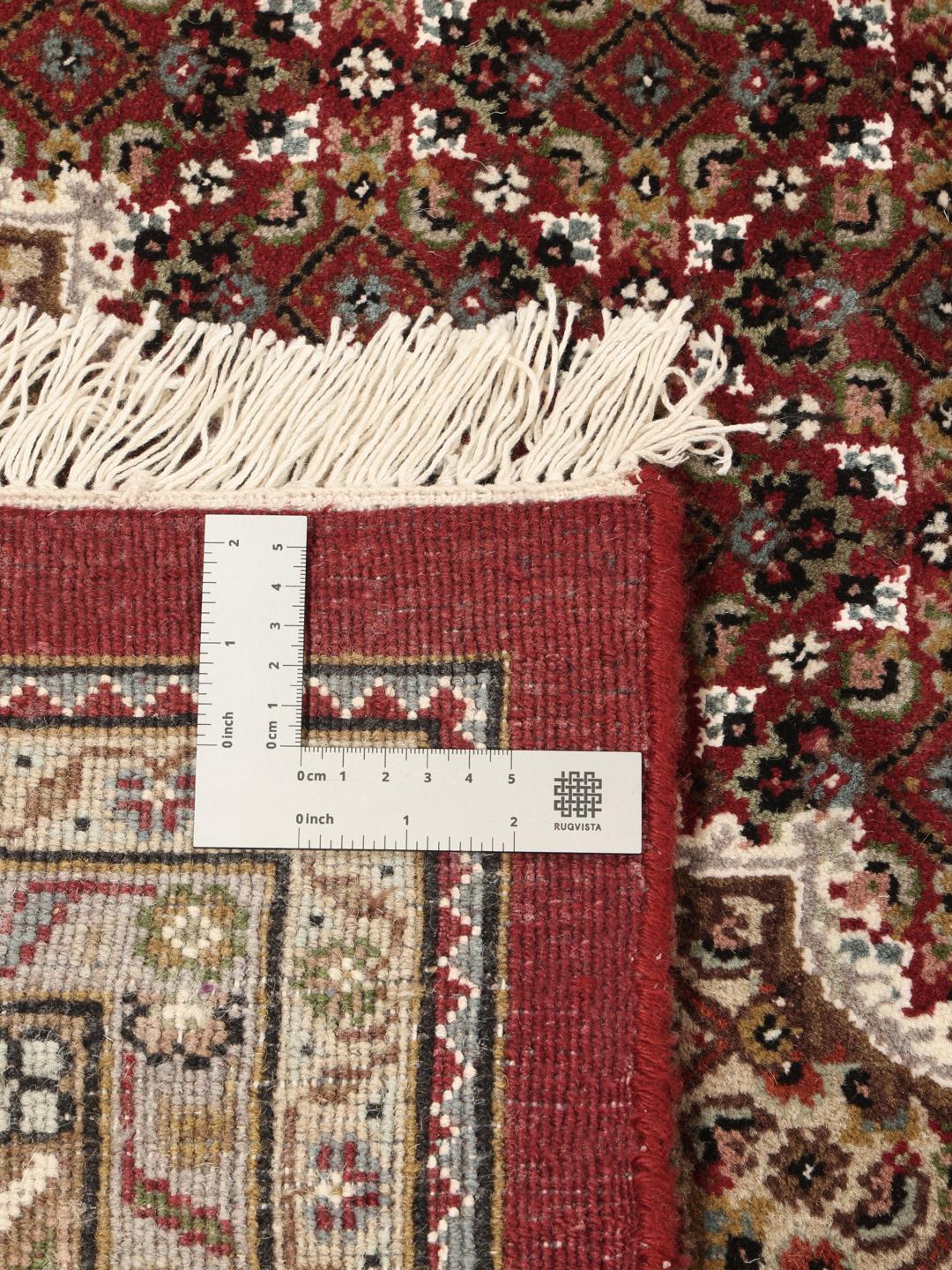 Tabriz Royal hand-knotted wool rug from India in deep red and beige tones