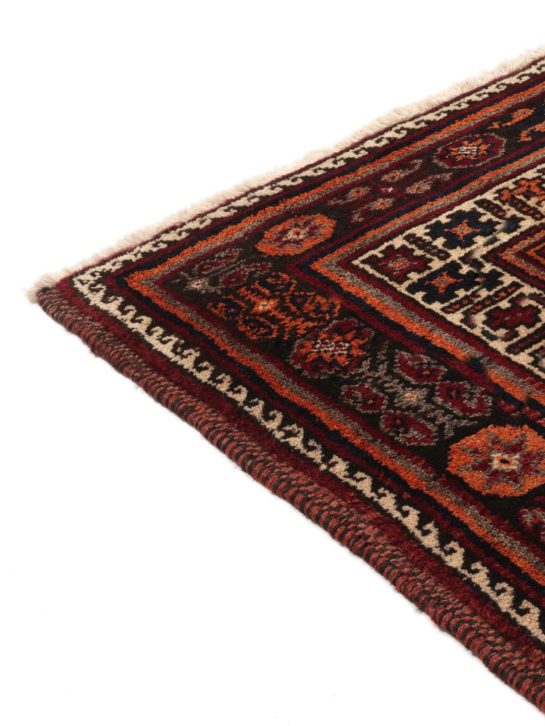 Hand-knotted Afshar rug from the Middle East with a red and dark-red geometric design