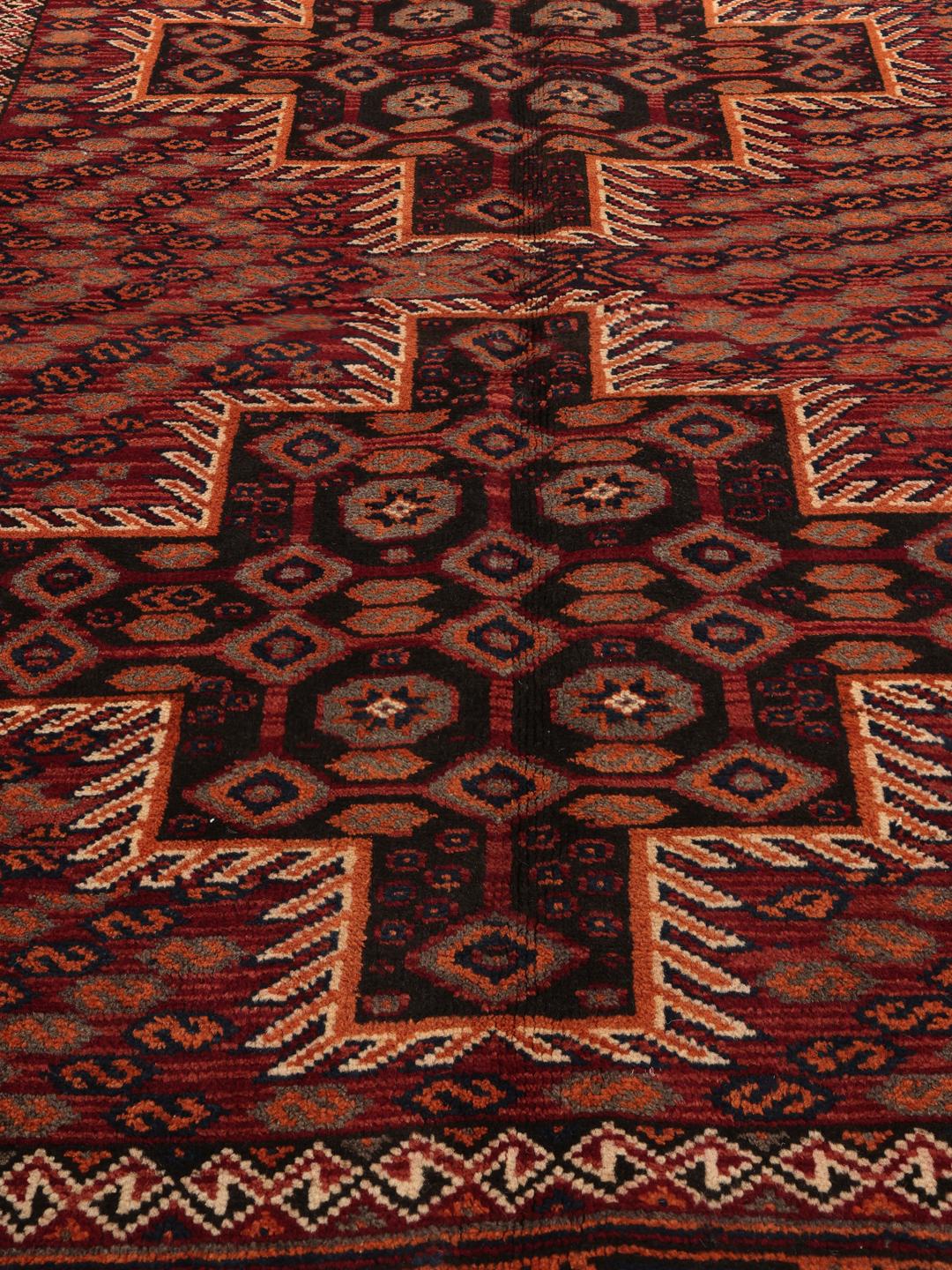 Hand-knotted Afshar rug from the Middle East with a red and dark-red geometric design