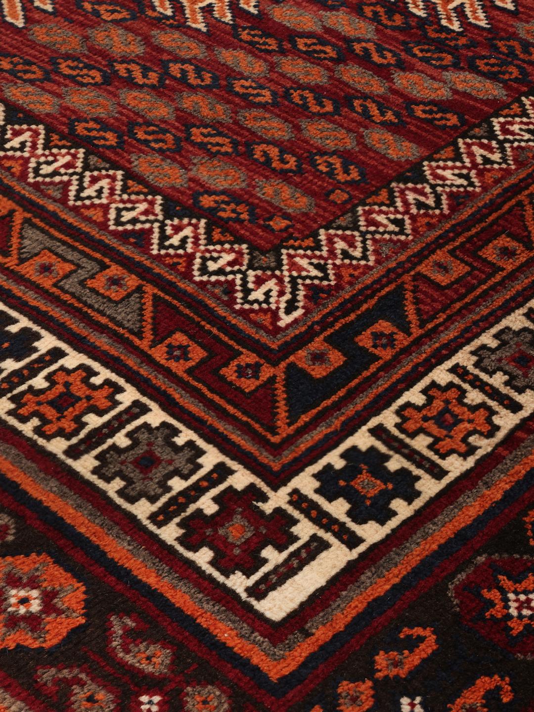 Hand-knotted Afshar rug from the Middle East with a red and dark-red geometric design