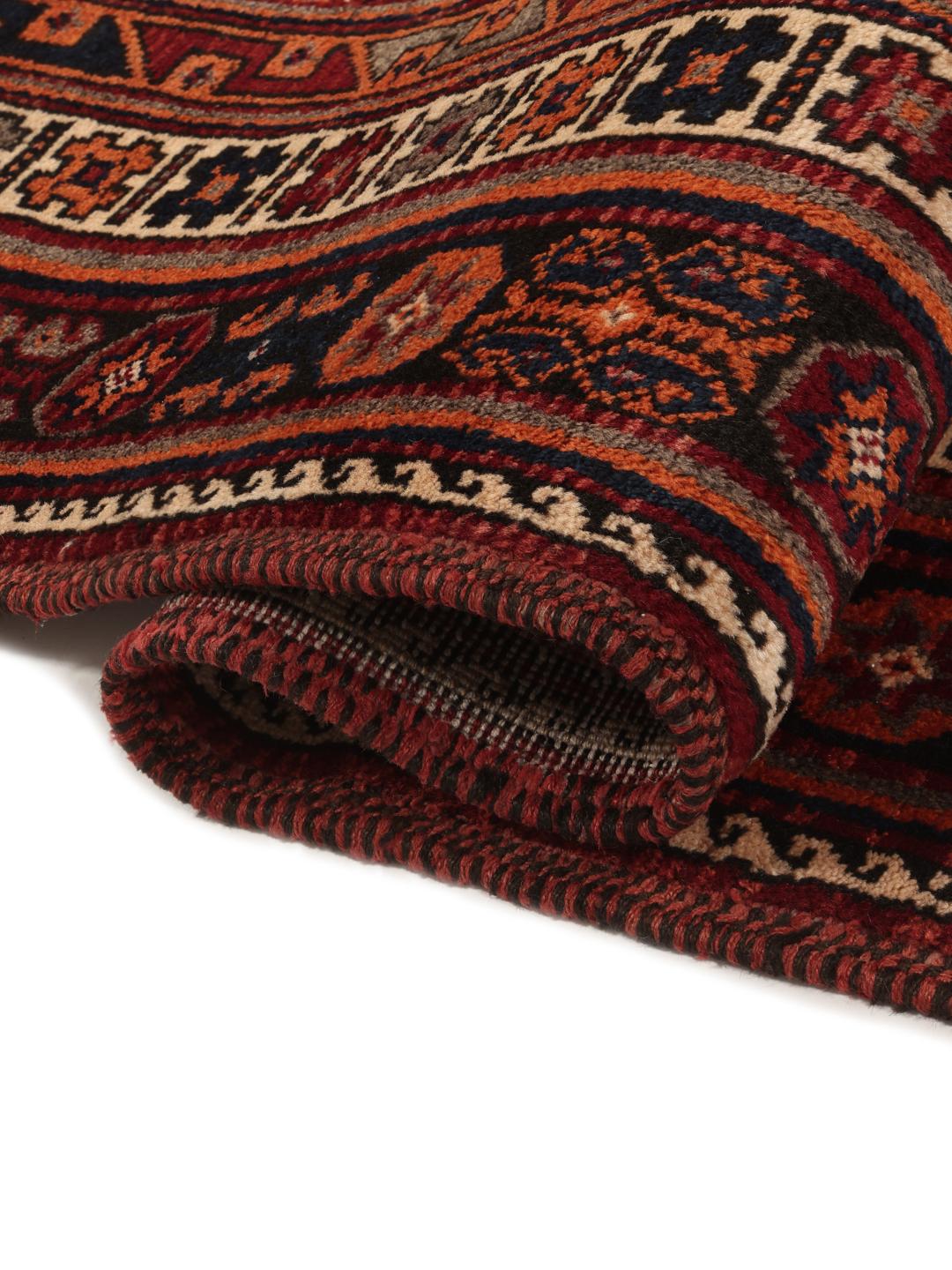 Hand-knotted Afshar rug from the Middle East with a red and dark-red geometric design