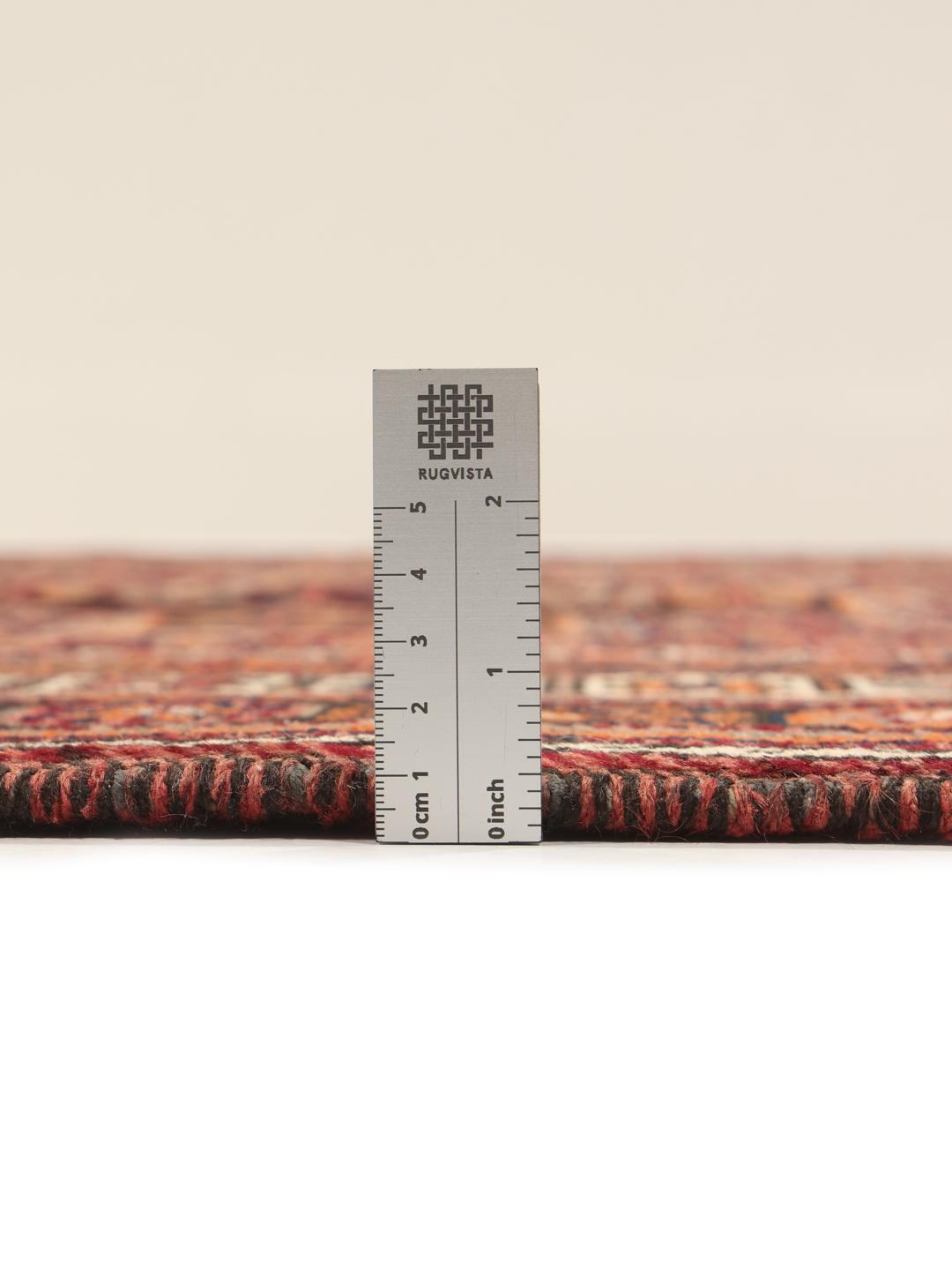 Hand-knotted Afshar rug from the Middle East with a red and dark-red geometric design