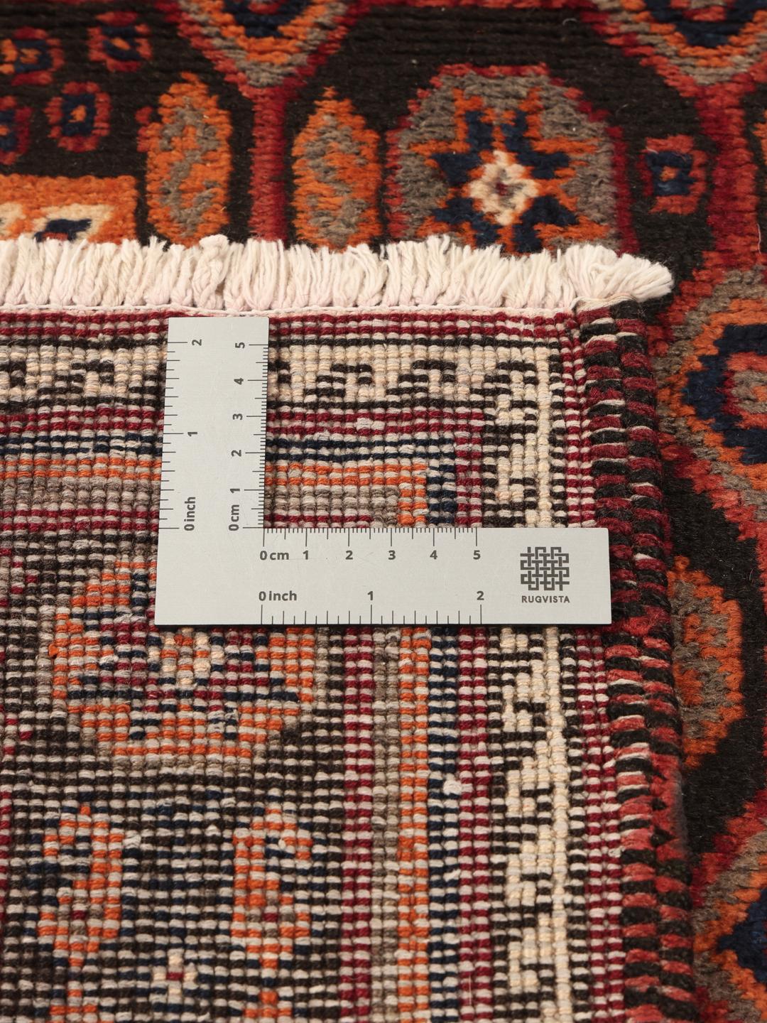 Hand-knotted Afshar rug from the Middle East with a red and dark-red geometric design