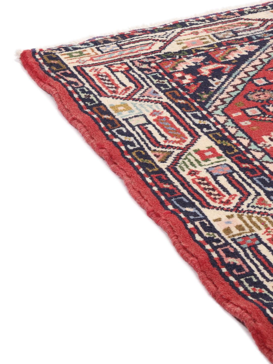 A hand-knotted Hamadan rug from the Middle East featuring a vibrant red and dark blue geometric pattern.
