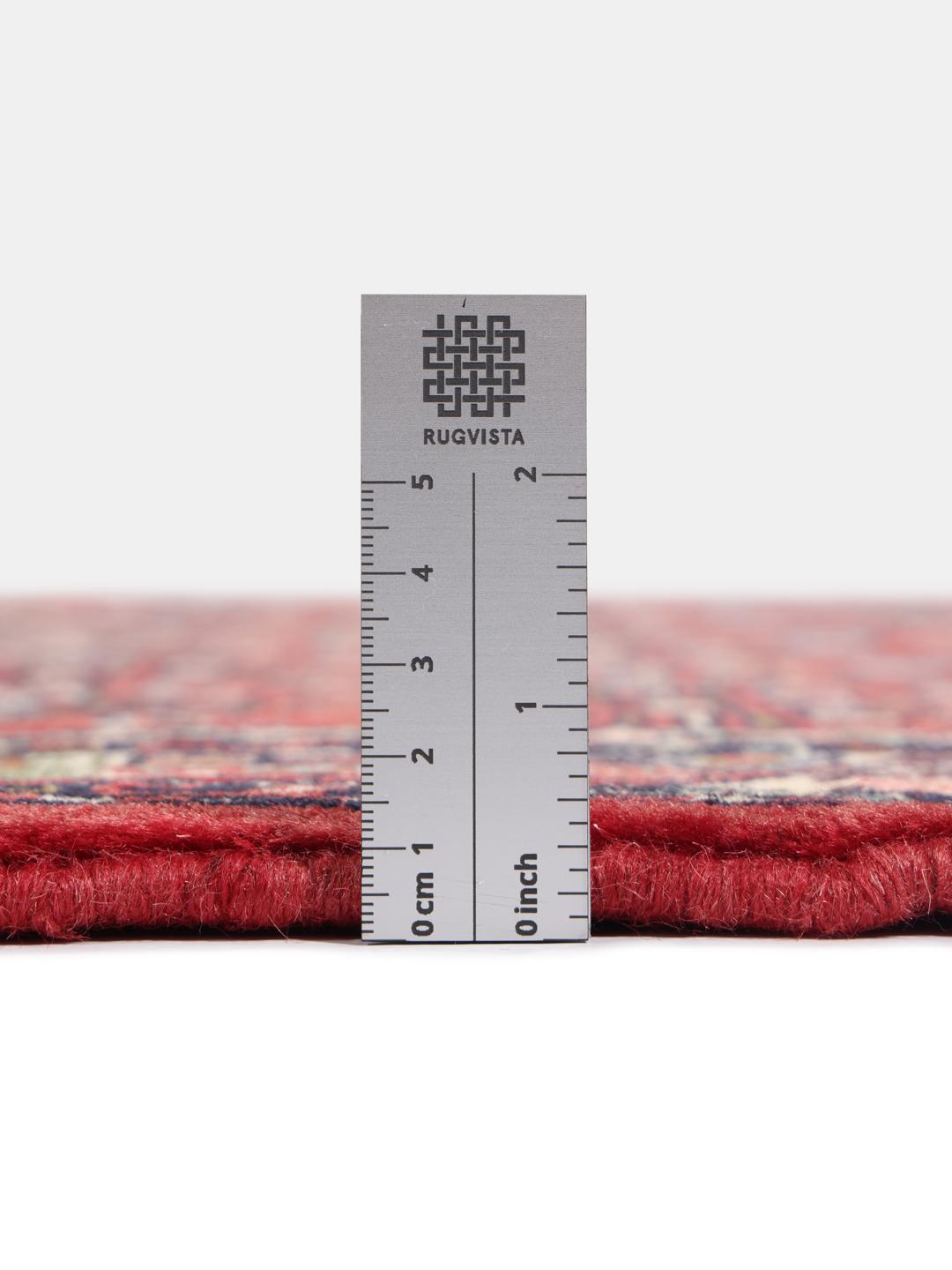 A hand-knotted Hamadan rug from the Middle East featuring a vibrant red and dark blue geometric pattern.