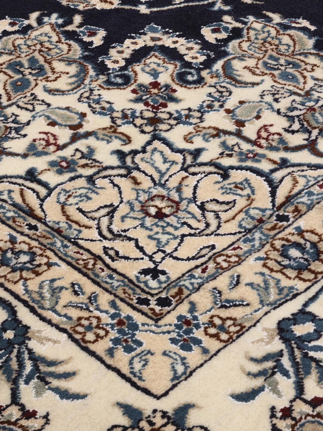 Hand-knotted Nain rug from the Middle East with a dark-blue and cream floral design