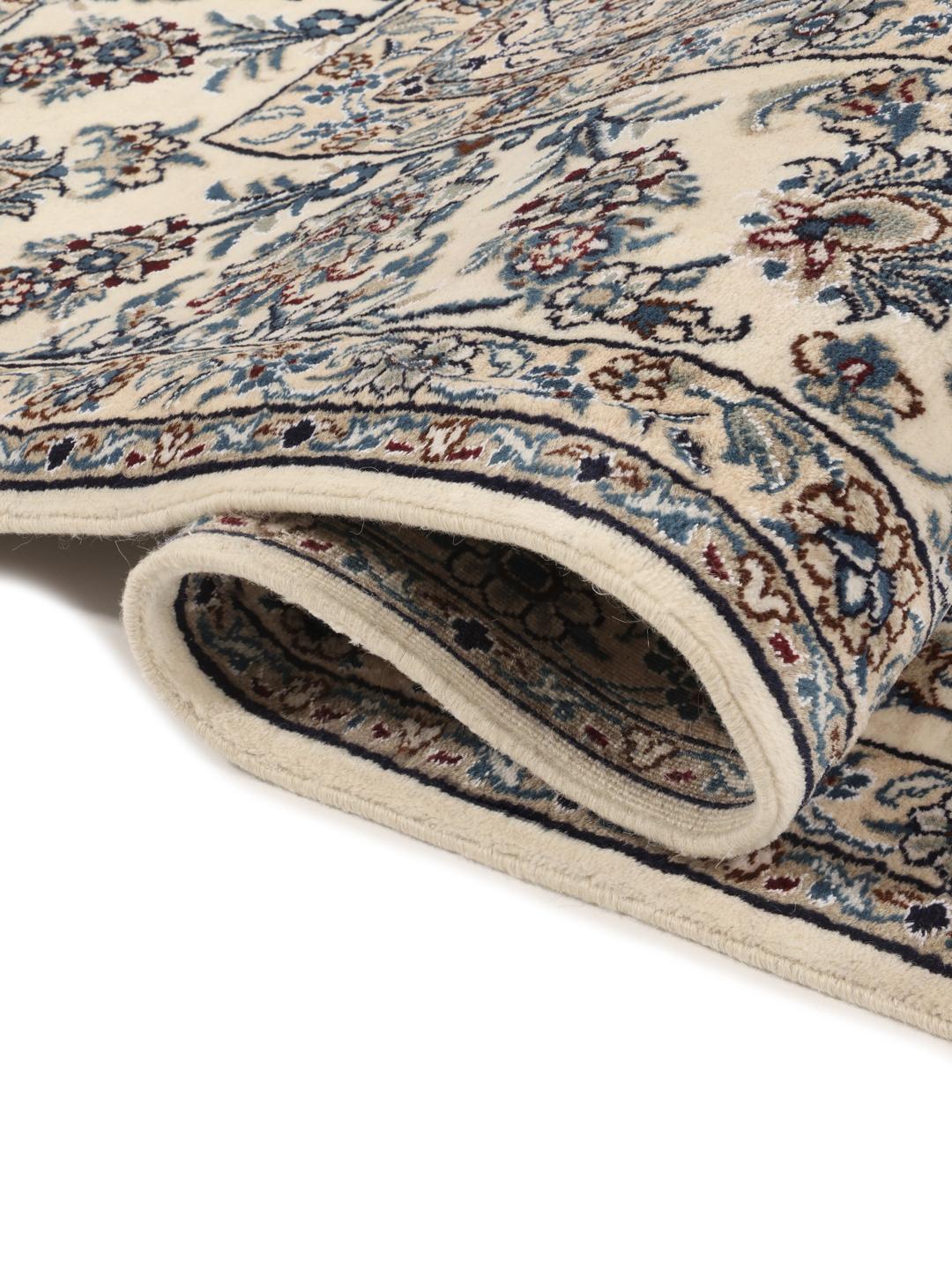 Hand-knotted Nain rug from the Middle East with a dark-blue and cream floral design
