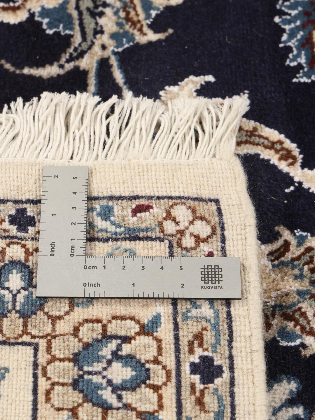 Hand-knotted Nain rug from the Middle East with a dark-blue and cream floral design