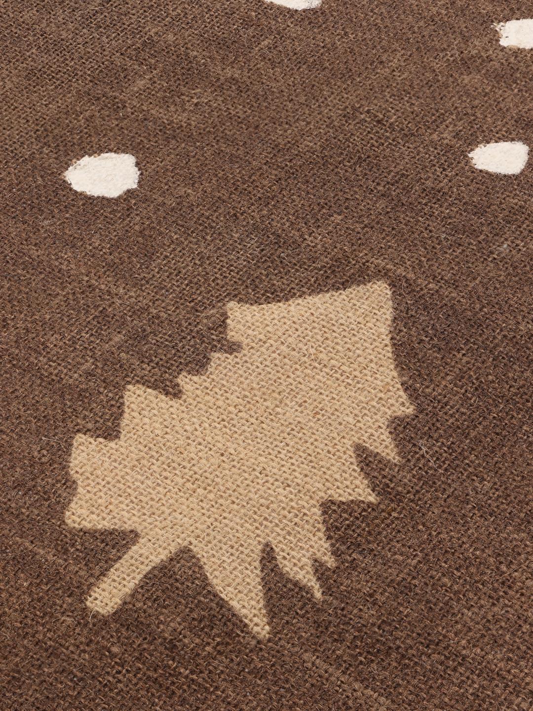 Round brown rug with pine tree and dot pattern
