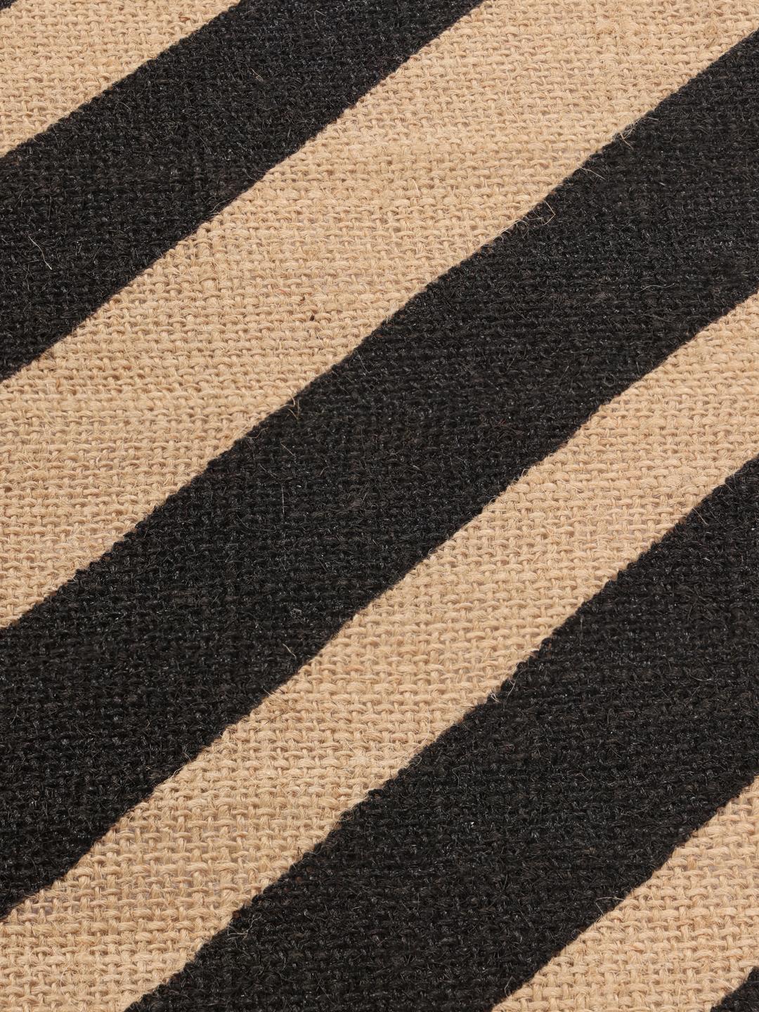 round beige and black rug with fringe and stripes