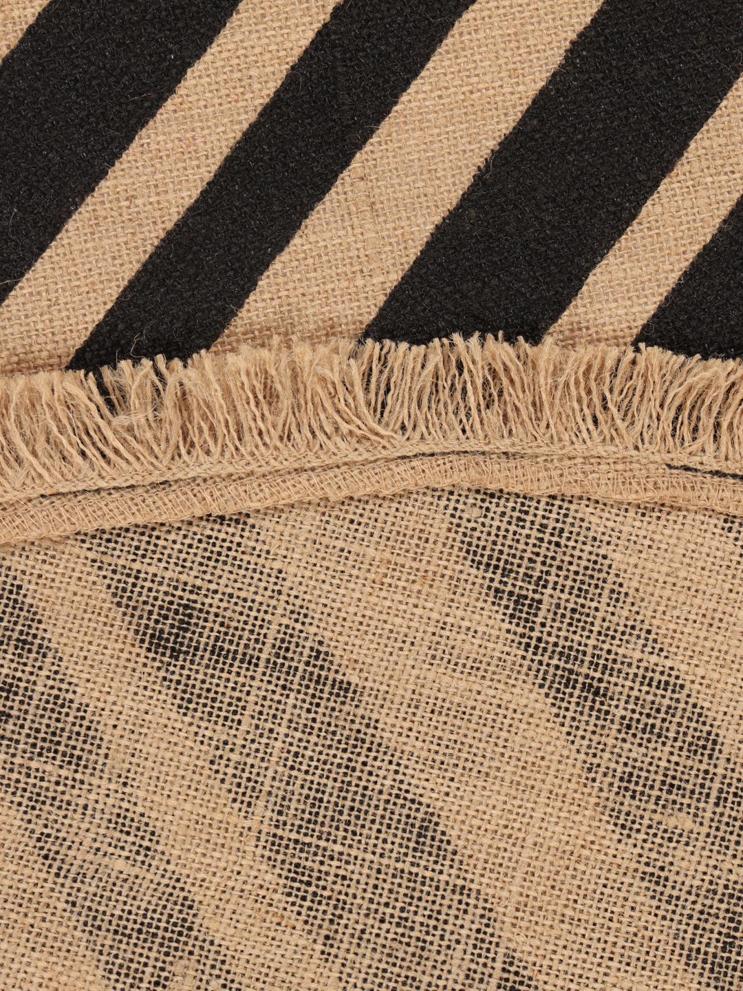 round beige and black rug with fringe and stripes