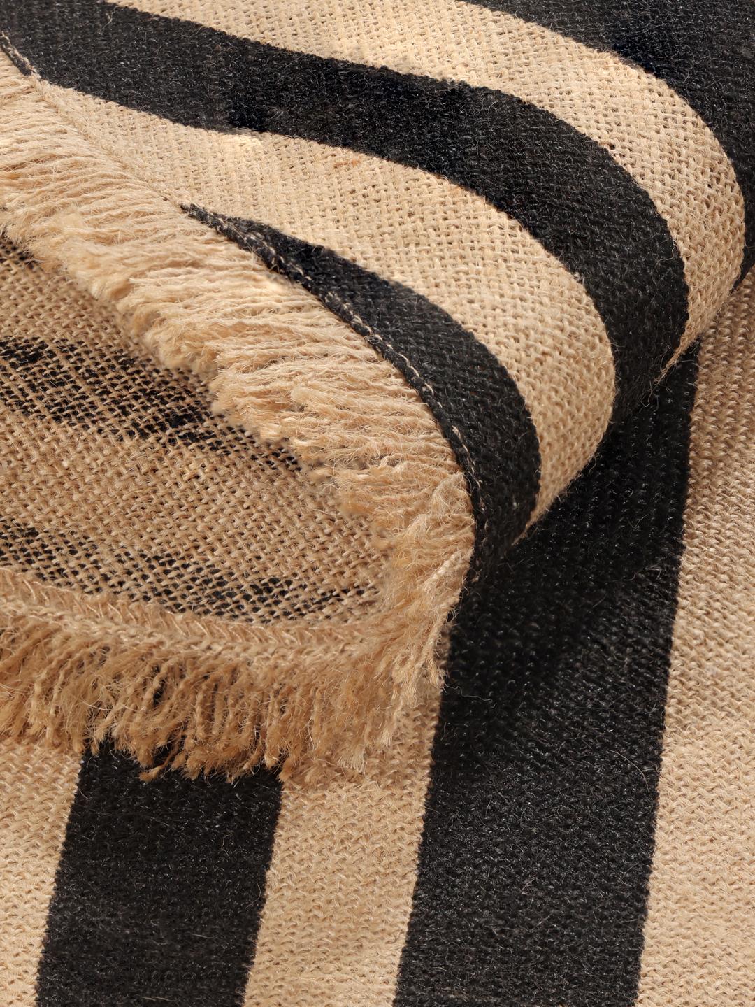 round beige and black rug with fringe and stripes