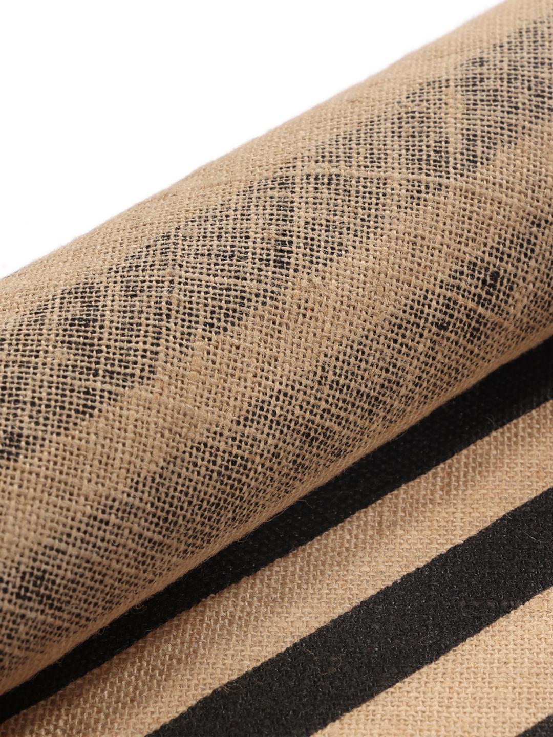 round beige and black rug with fringe and stripes