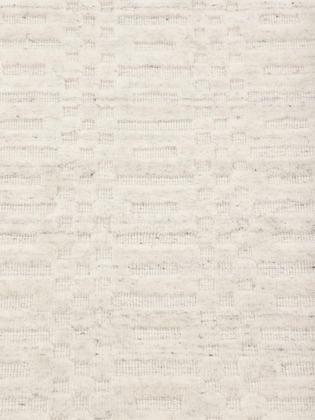 Beige tapijt met subtiel textuurpatroon en minimalistisch design