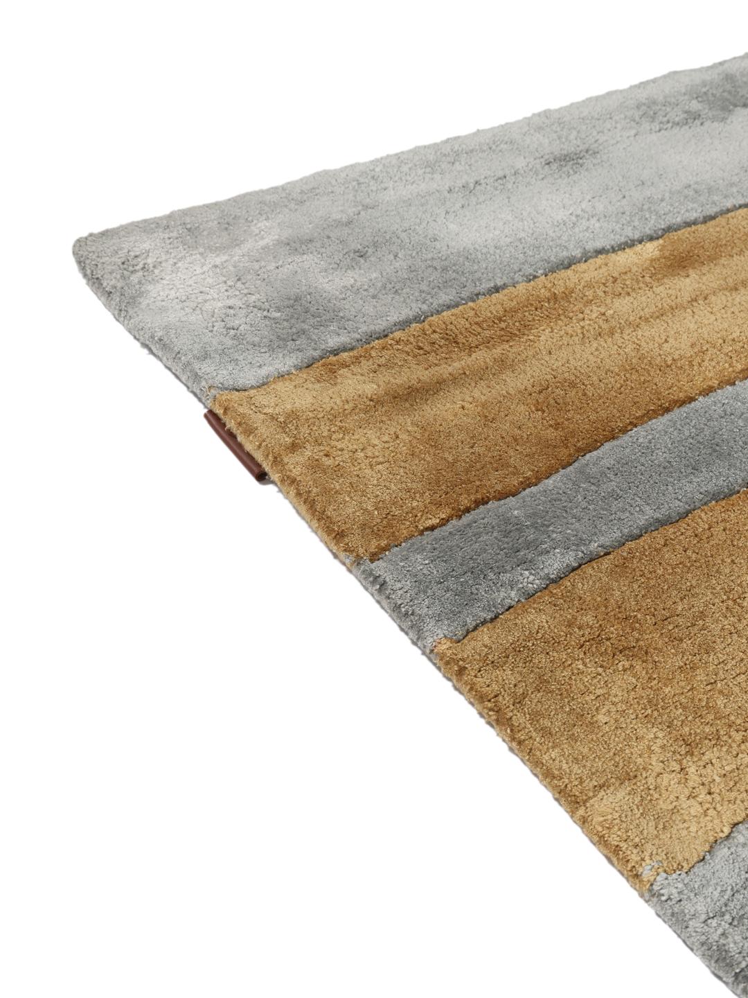 Eigentijds abstract vloerkleed met roze, grijze en gouden geometrische vormen