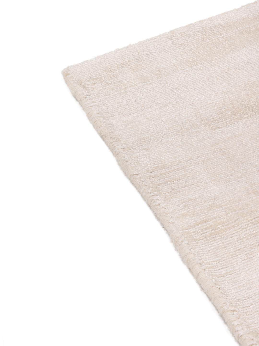 Square beige rug with minimalist dark arrow accents