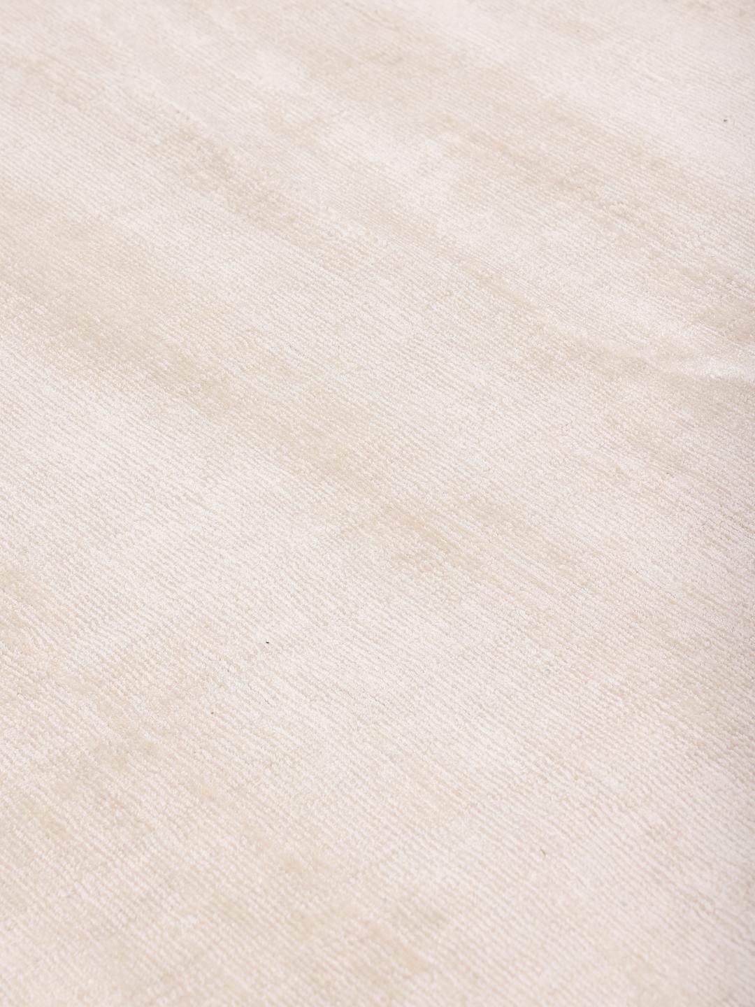 Square beige rug with minimalist dark arrow accents