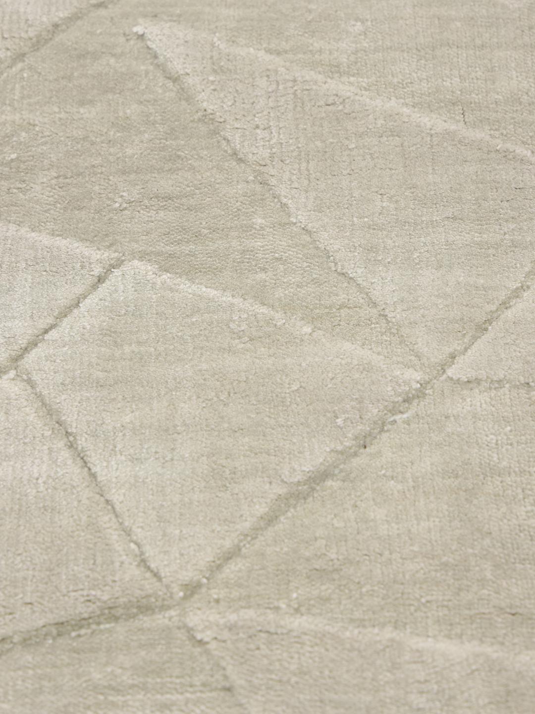 Beige tapijt met een subtiel geometrisch patroon en minimalistisch ontwerp