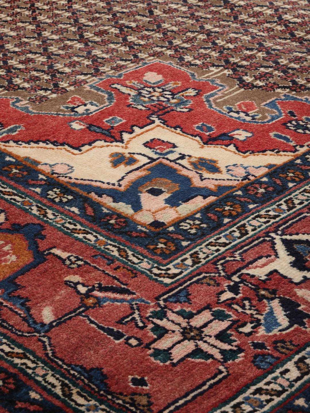 Handgeknoopt Koliai-tapijt uit het Midden-Oosten met een rood en blauw kleurenpalet