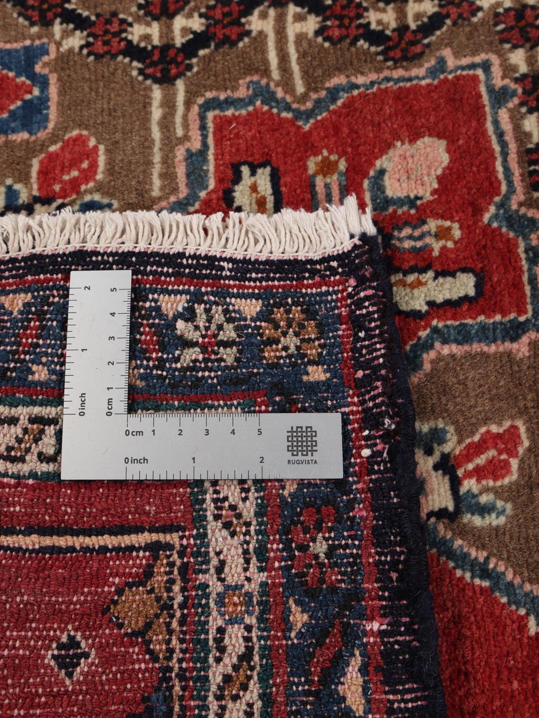 Handgeknoopt Koliai-tapijt uit het Midden-Oosten met een rood en blauw kleurenpalet