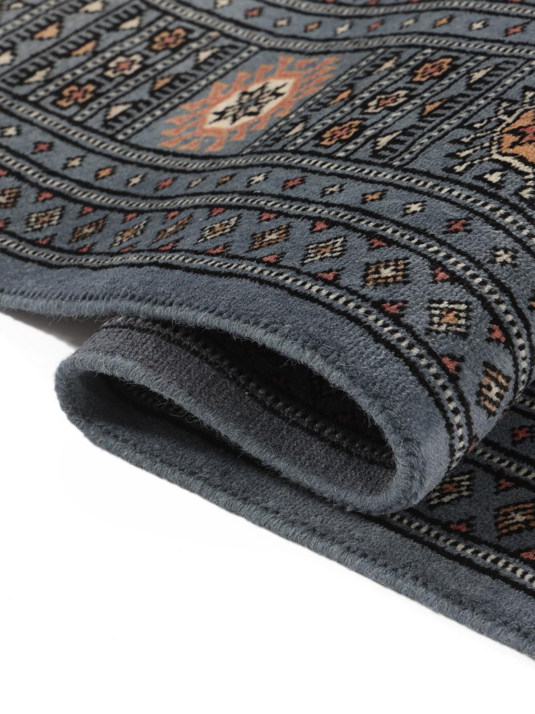 Handgeknoopt Pakistan Bokhara kleed met een blauw veld en herhalende motieven