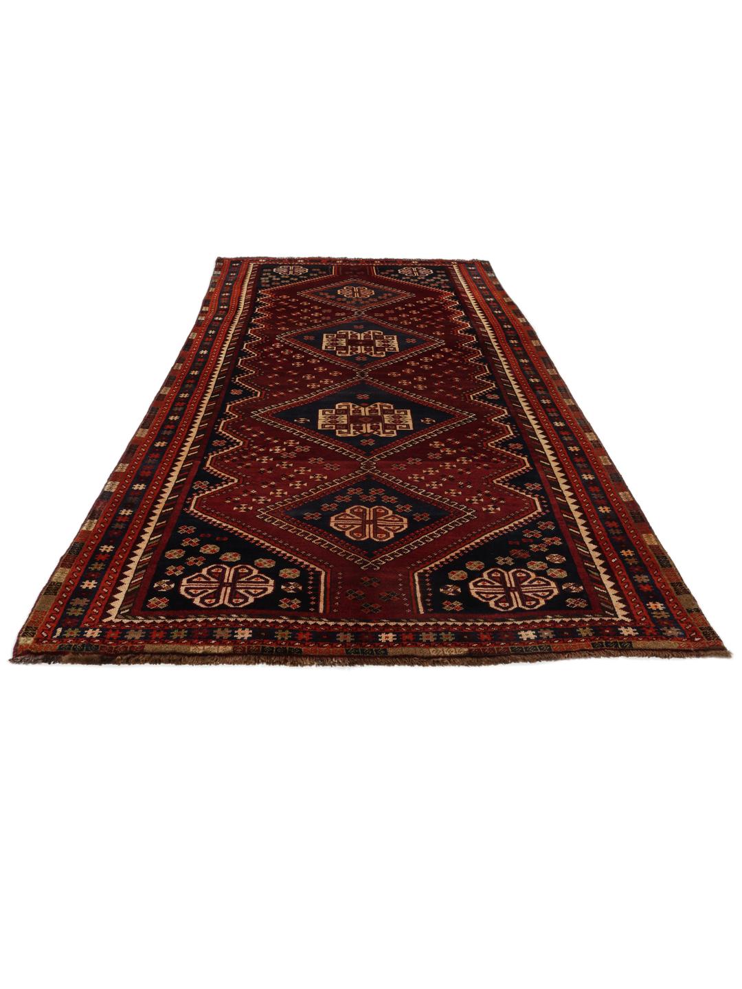 Handgeknoopt tapijt uit het Midden-Oosten in donkerrood met traditionele geometrische motieven