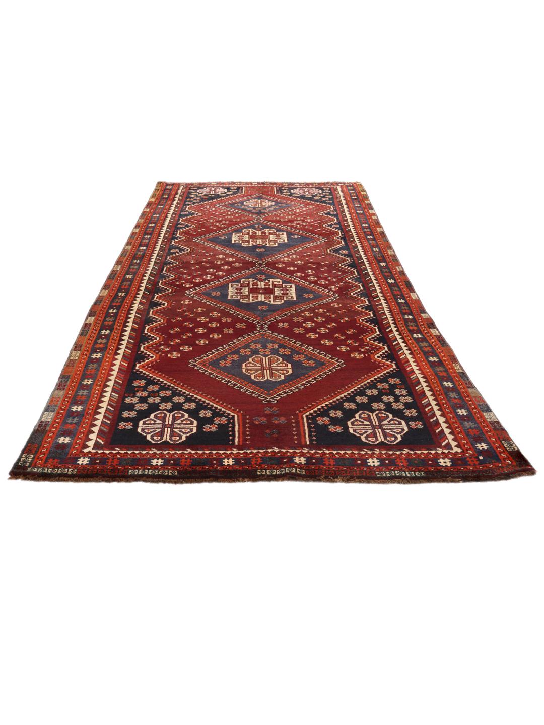 Handgeknoopt tapijt uit het Midden-Oosten in donkerrood met traditionele geometrische motieven