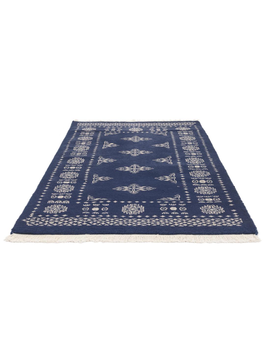 Hand-knotted wool rug from Pakistan in dark-blue with light-coloured geometric motifs.