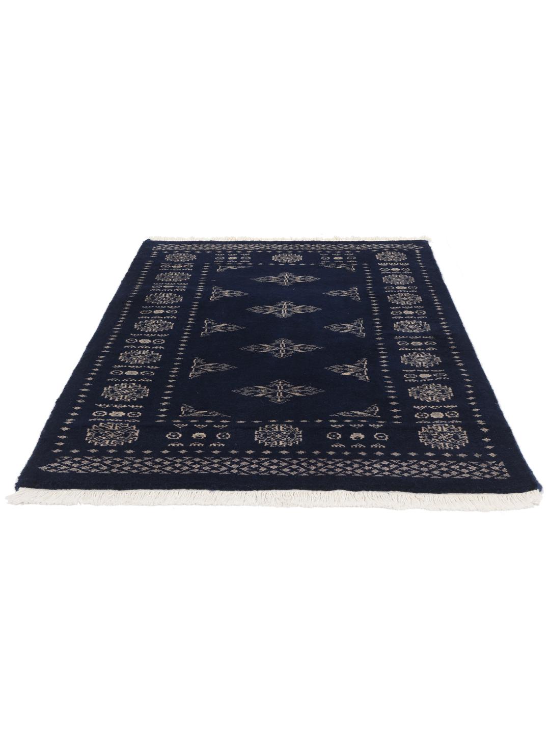 Hand-knotted wool rug from Pakistan in dark-blue with light-coloured geometric motifs.