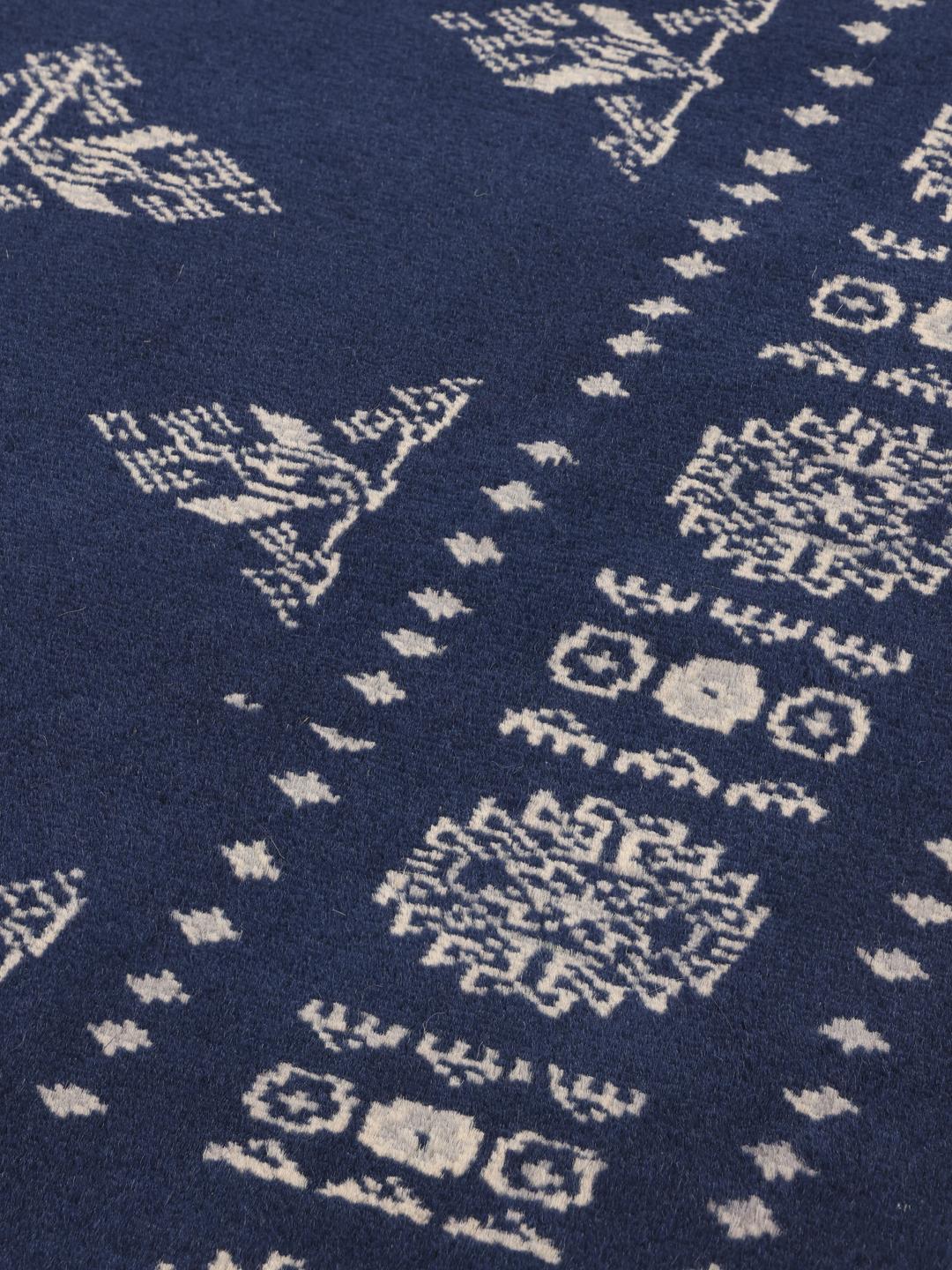 Hand-knotted wool rug from Pakistan in dark-blue with light-coloured geometric motifs.