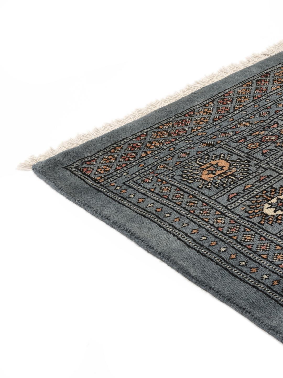 Hand-knotted Pakistan Bokhara rug in a serene blue with traditional motifs
