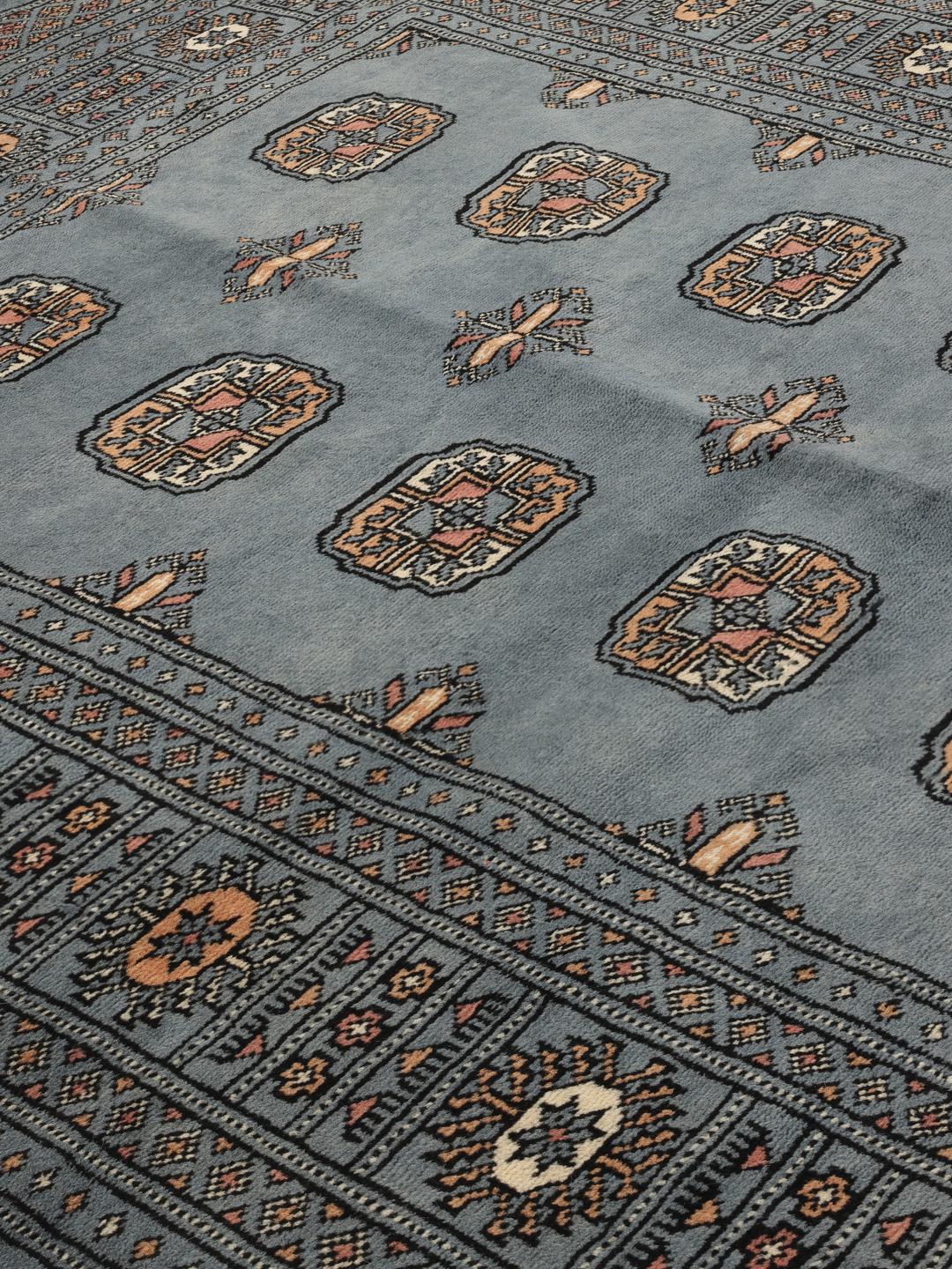 Hand-knotted Pakistan Bokhara rug in a serene blue with traditional motifs