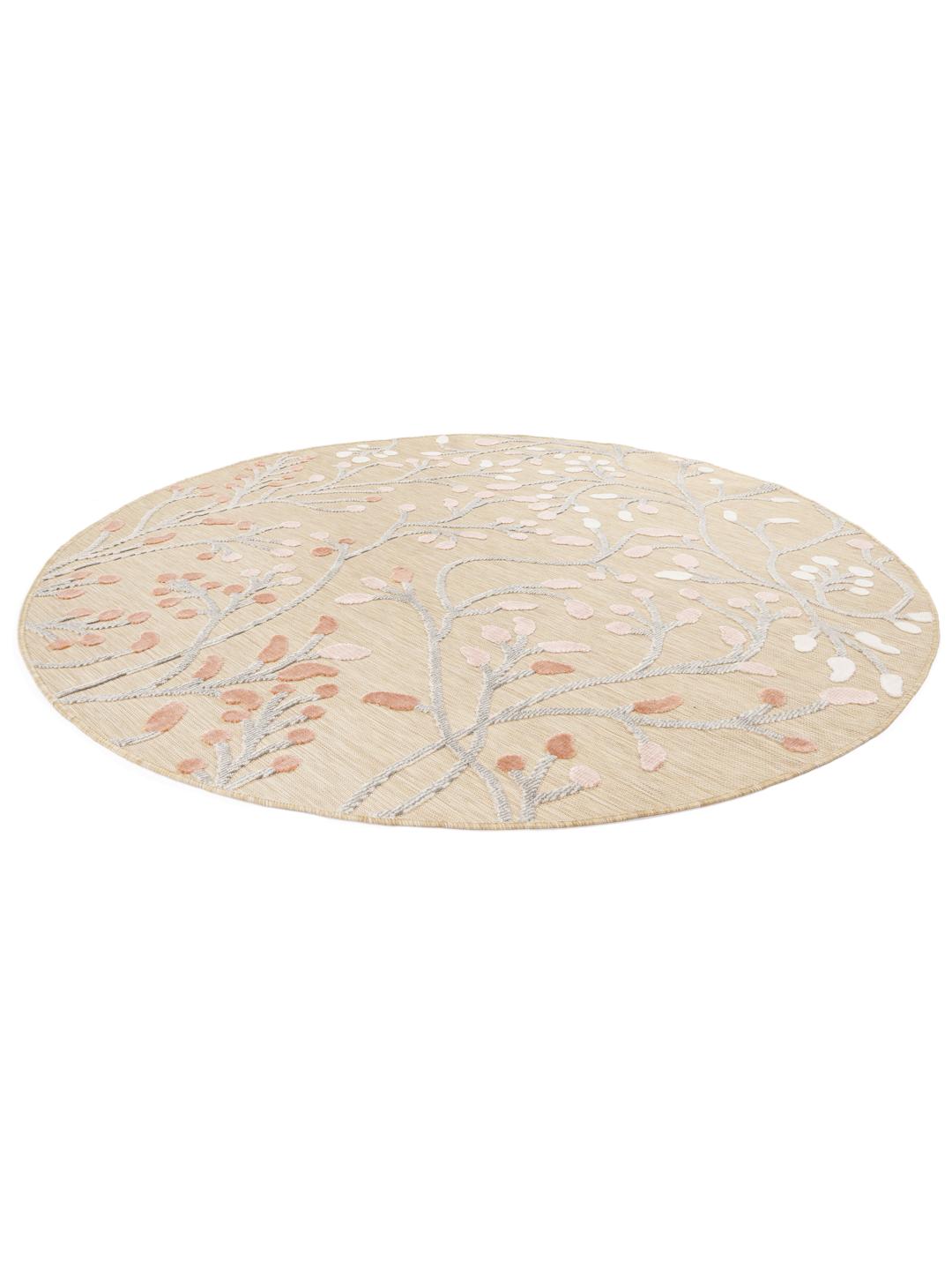 Tapis rond beige avec des motifs floraux roses