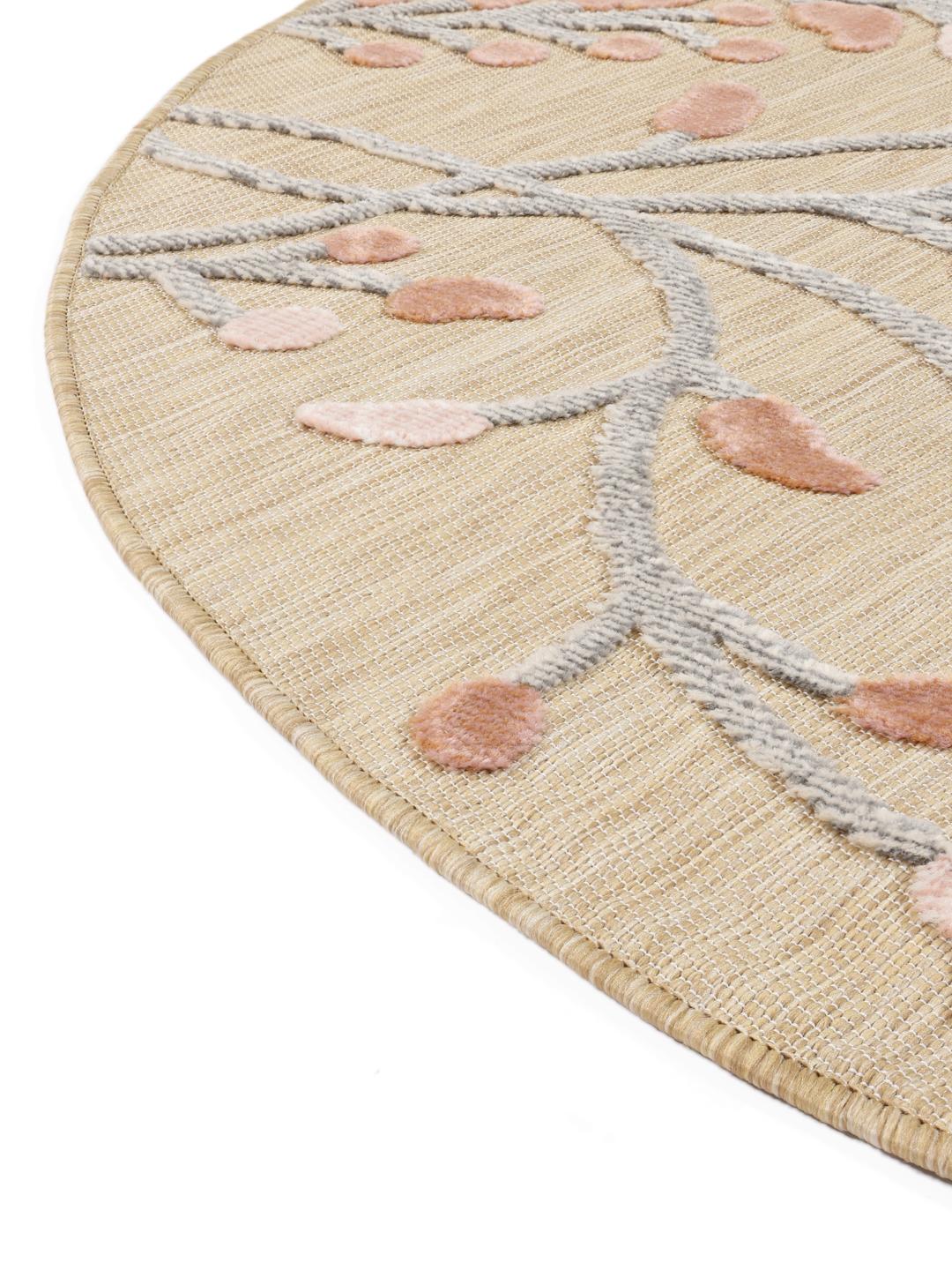 Tapis rond beige avec des motifs floraux roses