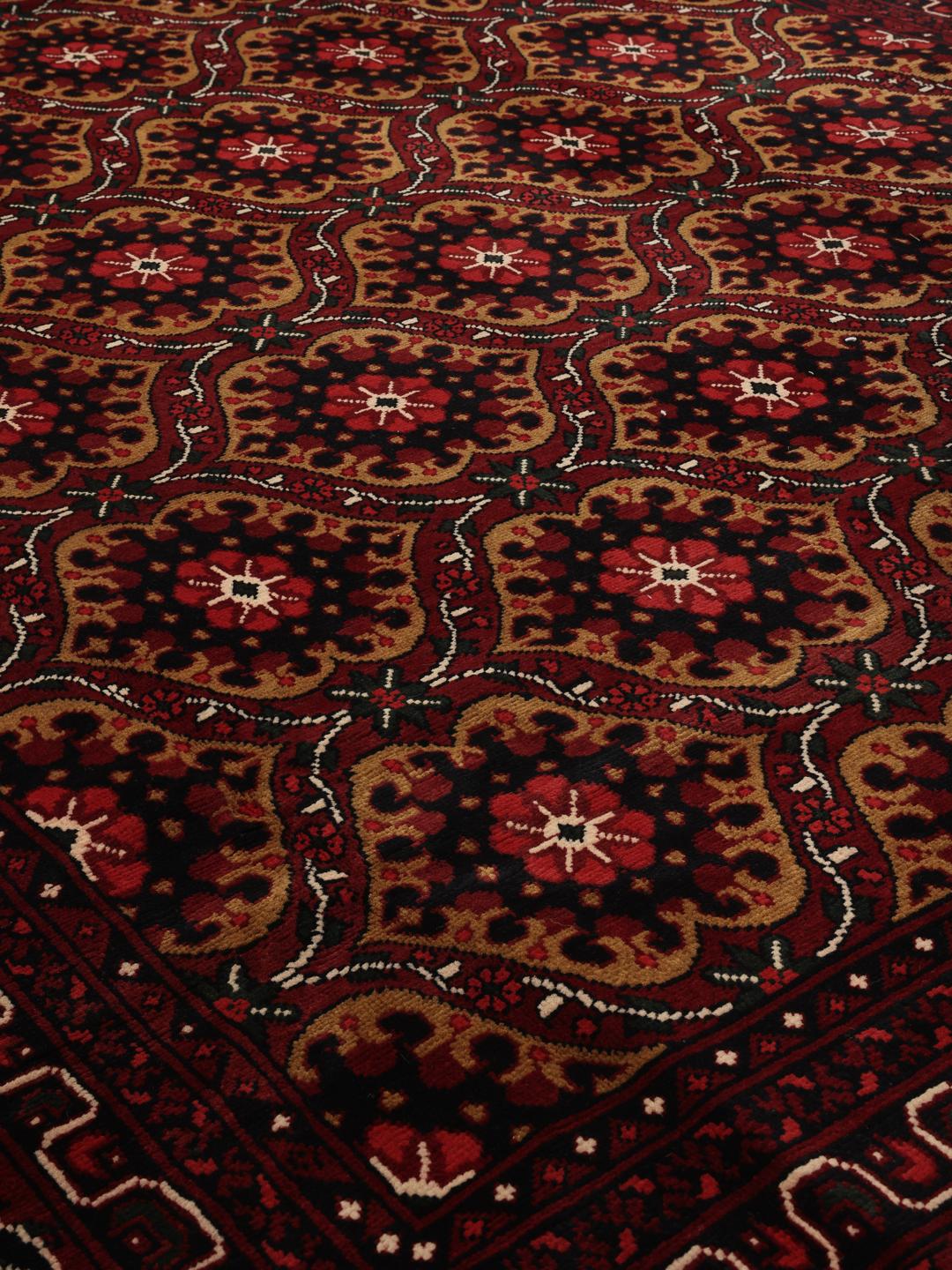 Hand-knotted Afghan Kunduz rug in dark-red with geometric medallions
