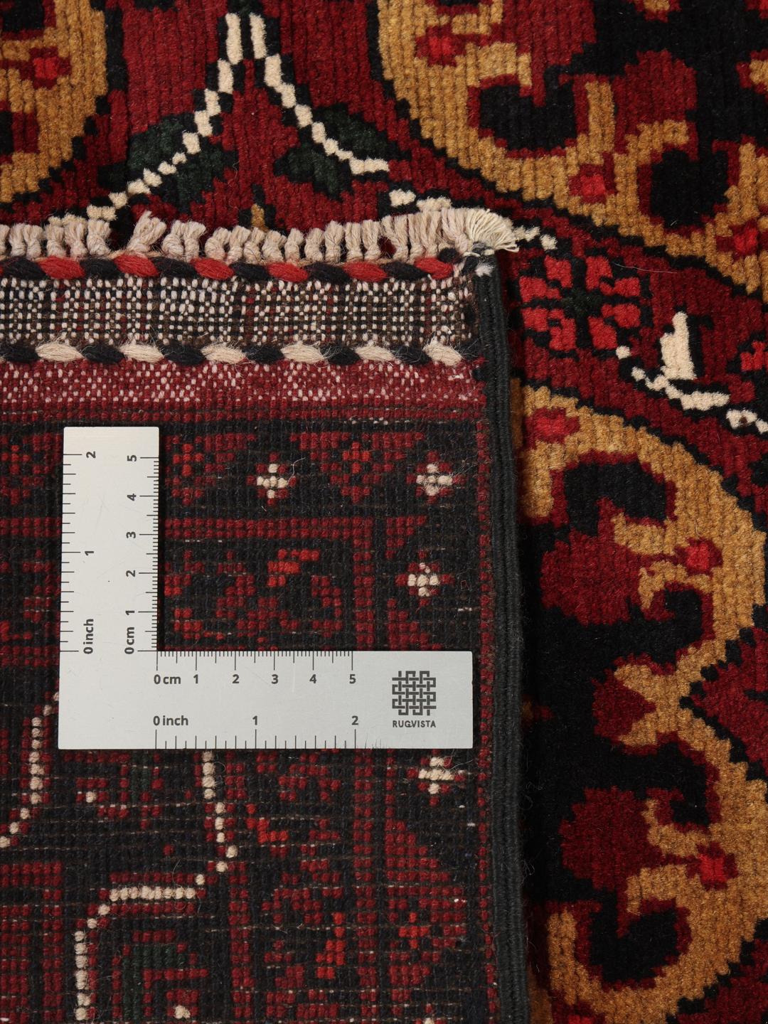 Hand-knotted Afghan Kunduz rug in dark-red with geometric medallions
