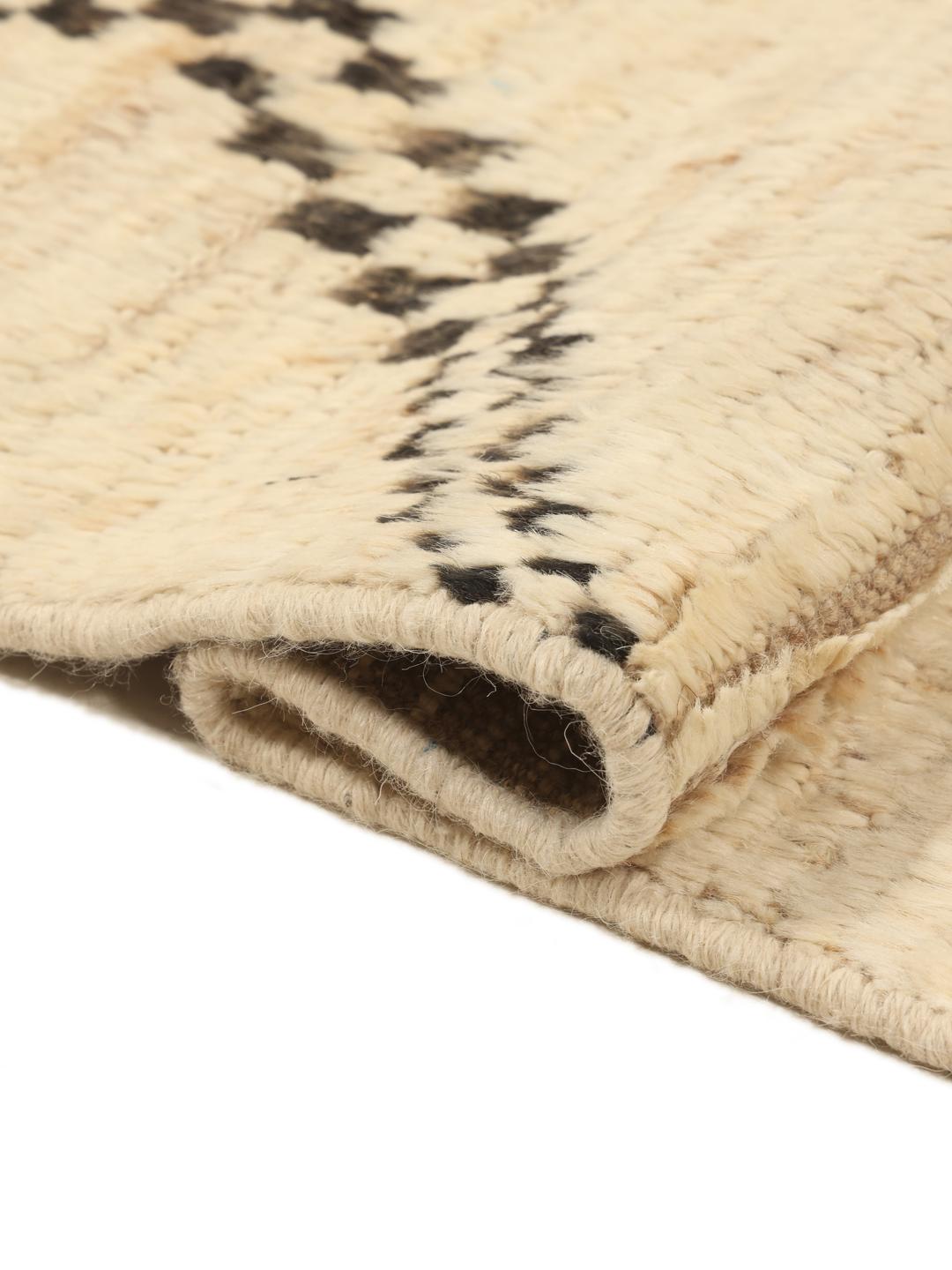 Hand-knotted Afghan rug with beige field and black geometric tribal motifs